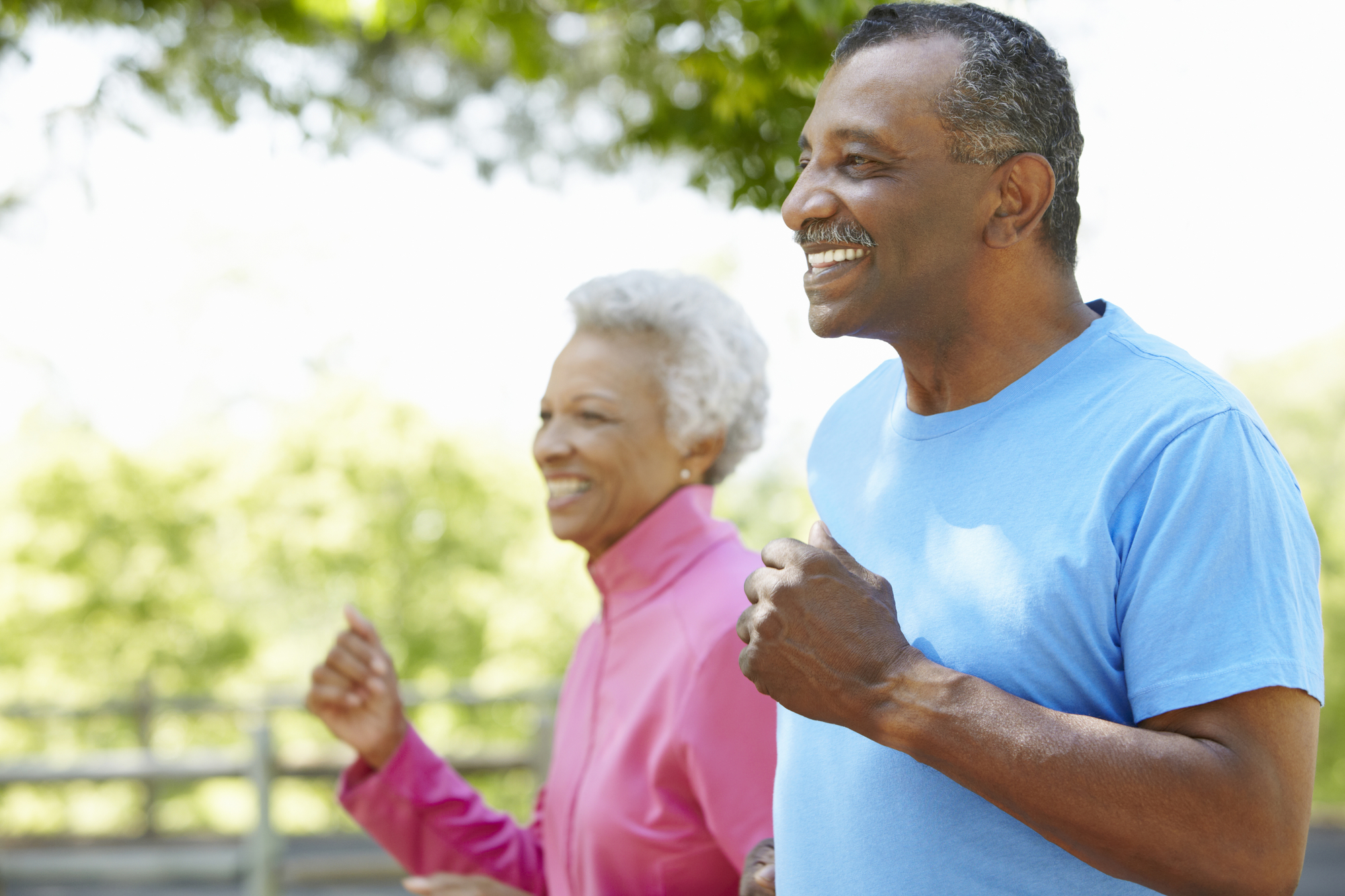 Senior Couple Jogging In Park